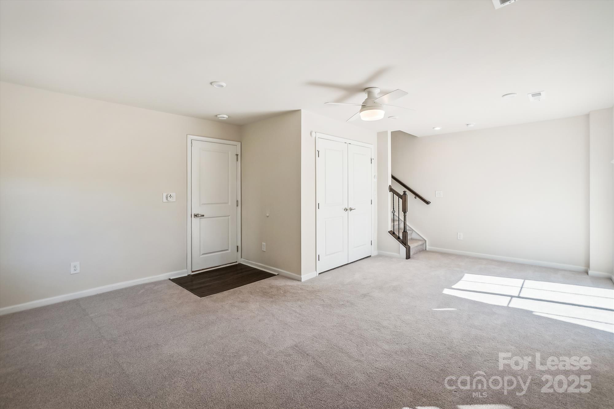 918 Portrush Lane Tega Cay, SC 29708 - Photo 6 of 36 an empty room with a ceiling fan and window