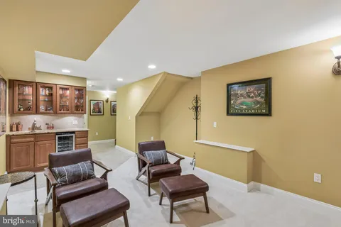 a living room with furniture and kitchen view