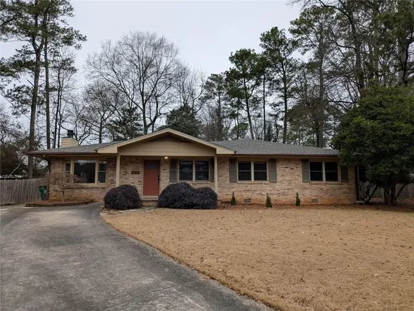 a front view of a house with yard covered in snow