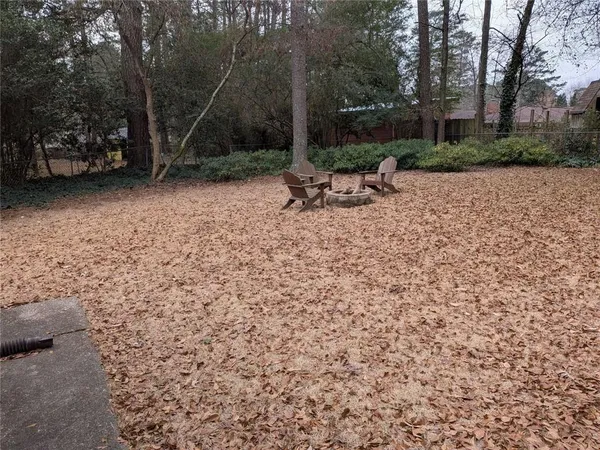 a backyard of a house with table and chairs