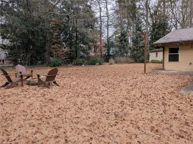 a white house that has a tree in front of it
