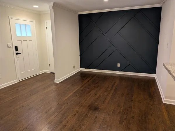 an empty room with wooden floor
