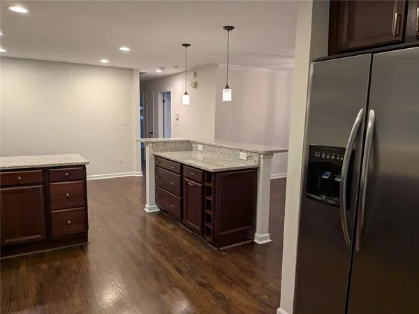 a kitchen with stainless steel appliances granite countertop a refrigerator and a stove