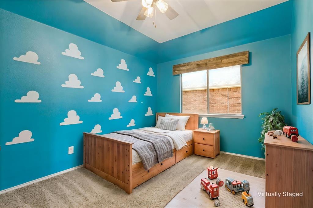 4107 Waverly Road Corinth, TX 76208 - Photo 22 of 30 This secondary bedroom includes a dreamy cloud accent wall, raised ceiling height, upgraded ceiling fan, custom wood winidow valance, neutral carpet and ample closet space.