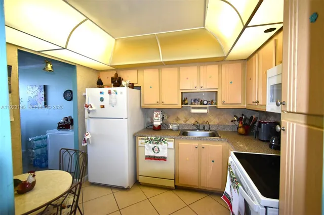 a kitchen with a sink appliances and cabinets