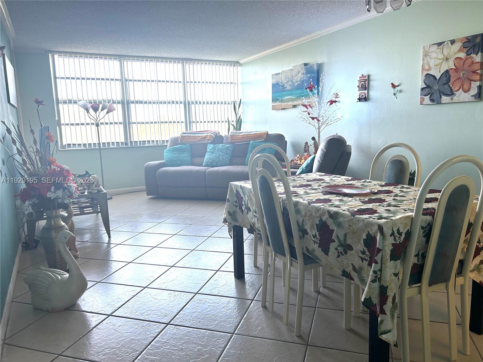 900 St Charles Place, Unit 606 Pembroke Pines, FL 33026 - Photo 11 of 36 a view of a dining room with furniture and a window