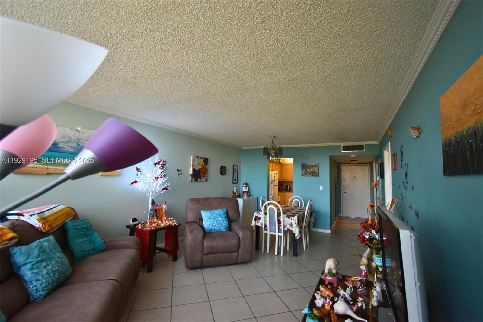 900 St Charles Place, Unit 606 Pembroke Pines, FL 33026 - Photo 14 of 36 a living room with furniture and potted plants