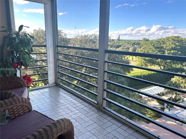 a bedroom with furniture and a large window