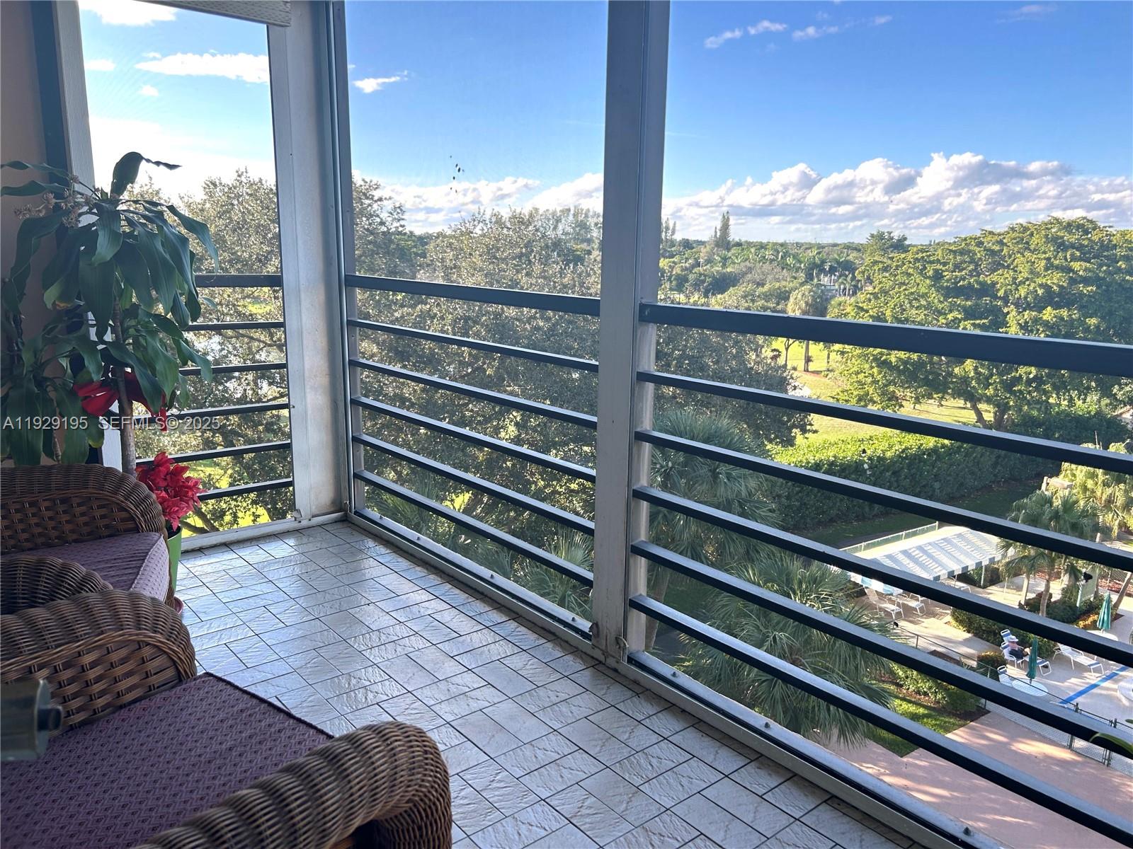 900 St Charles Place, Unit 606 Pembroke Pines, FL 33026 - Photo 16 of 36 a bedroom with furniture and a large window