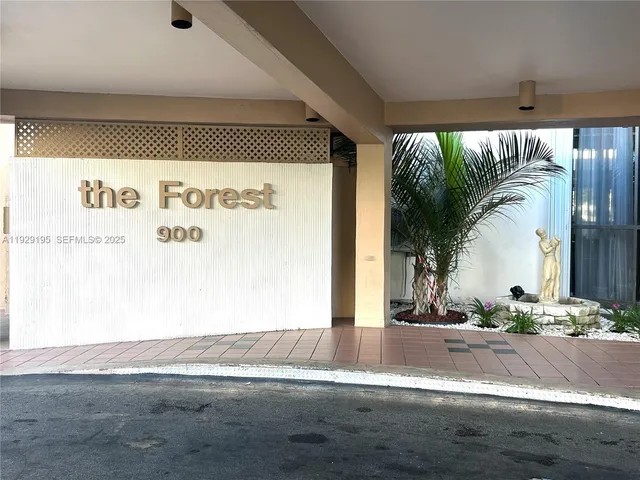 a view of a floor to ceiling window and a tree