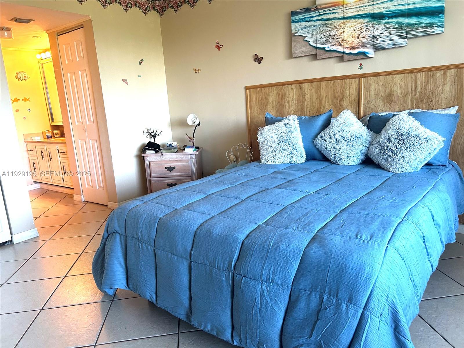 900 St Charles Place, Unit 606 Pembroke Pines, FL 33026 - Photo 4 of 36 a bedroom with a bed and wooden floor