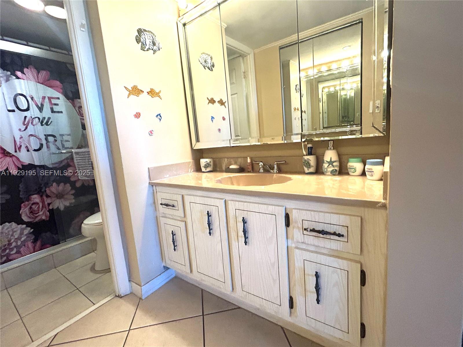 900 St Charles Place, Unit 606 Pembroke Pines, FL 33026 - Photo 5 of 36 a bathroom with a sink and a mirror