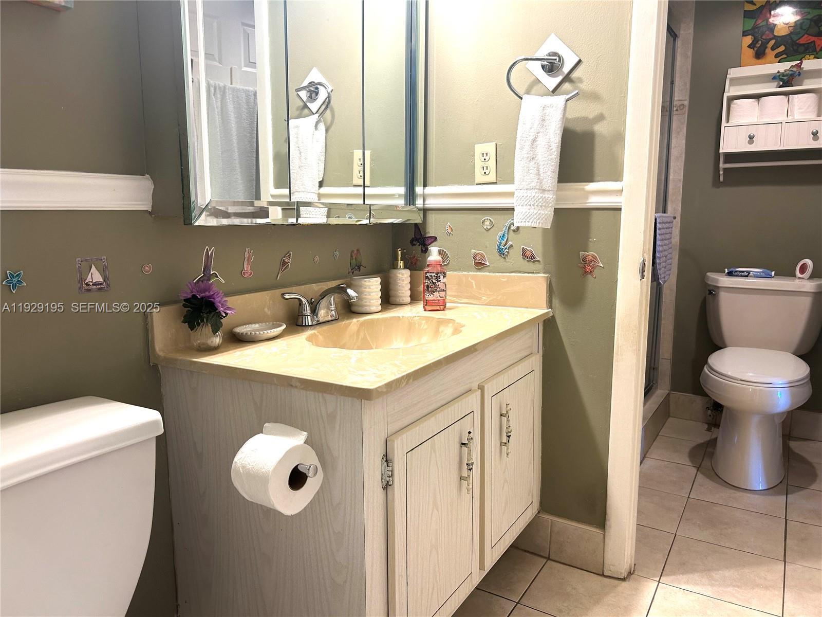 900 St Charles Place, Unit 606 Pembroke Pines, FL 33026 - Photo 8 of 36 a bathroom with a sink a toilet and a mirror