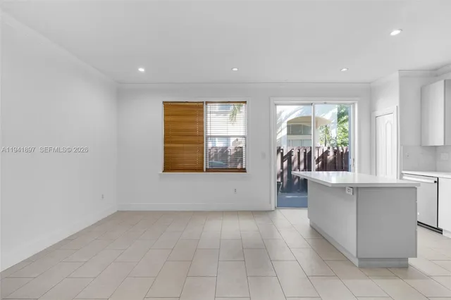 a view of a kitchen with microwave and windows