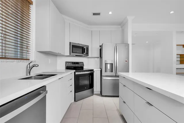 a kitchen with a sink stove and refrigerator