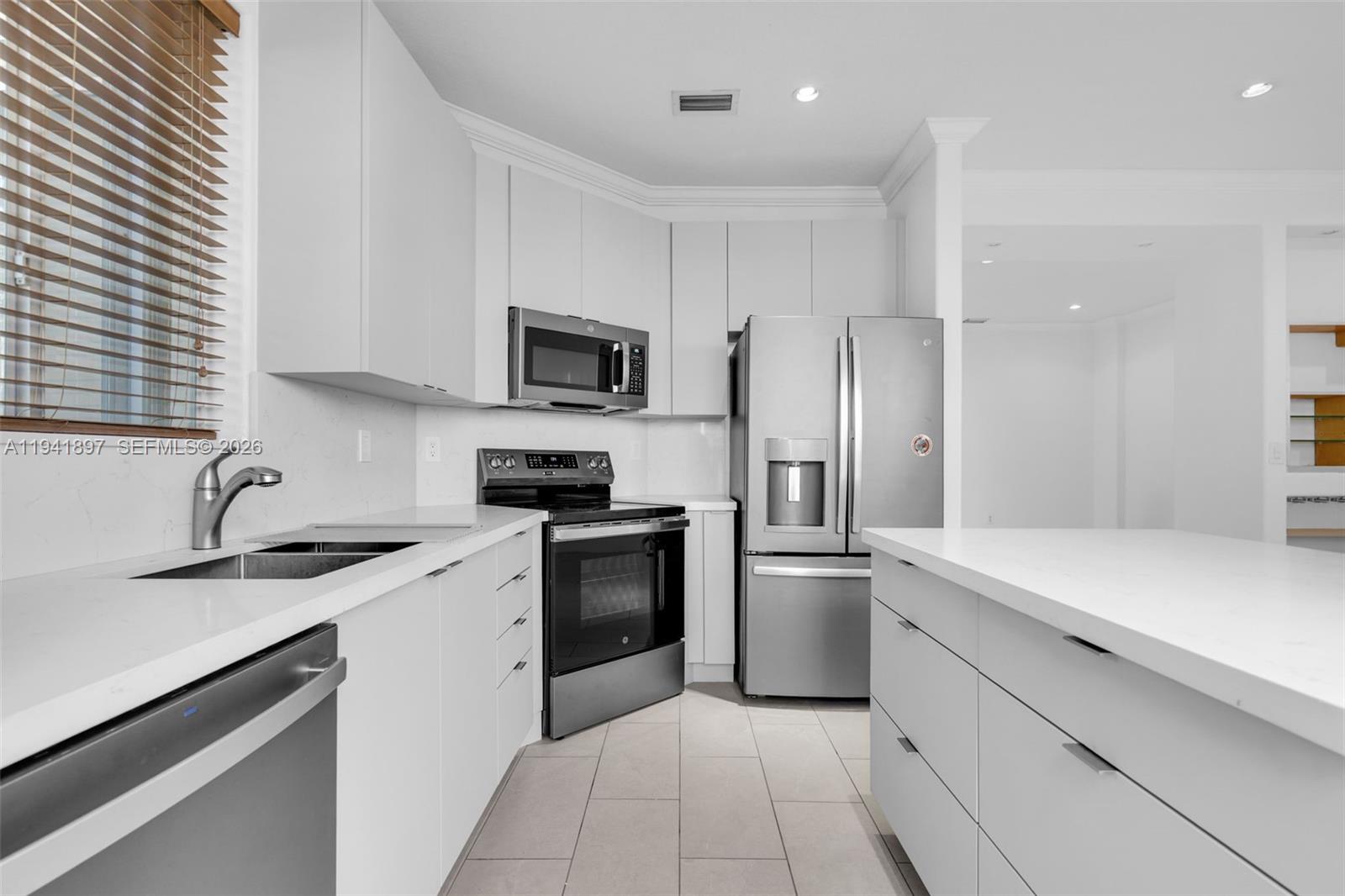 5505 Northwest 112th Path, Unit 5505 Doral, FL 33178 - Photo 14 of 44 a kitchen with a sink stove and refrigerator