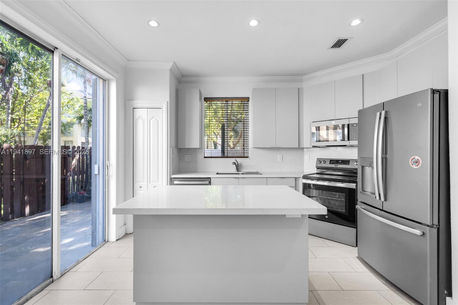5505 Northwest 112th Path, Unit 5505 Doral, FL 33178 - Photo 15 of 44 a kitchen with stainless steel appliances a refrigerator sink and cabinets