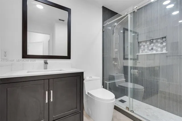 a bathroom with a sink toilet and shower