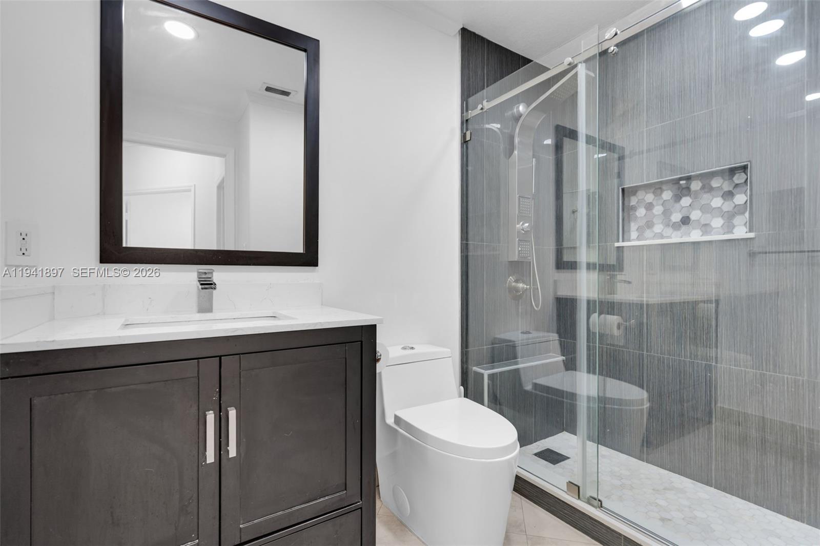 5505 Northwest 112th Path, Unit 5505 Doral, FL 33178 - Photo 18 of 44 a bathroom with a sink toilet and shower