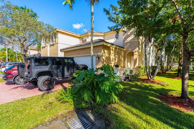 a view of a chair and tables in the back yard of the house