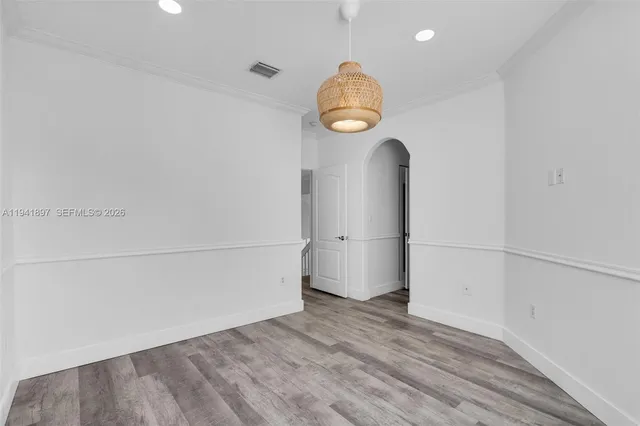 an empty room with wooden floor