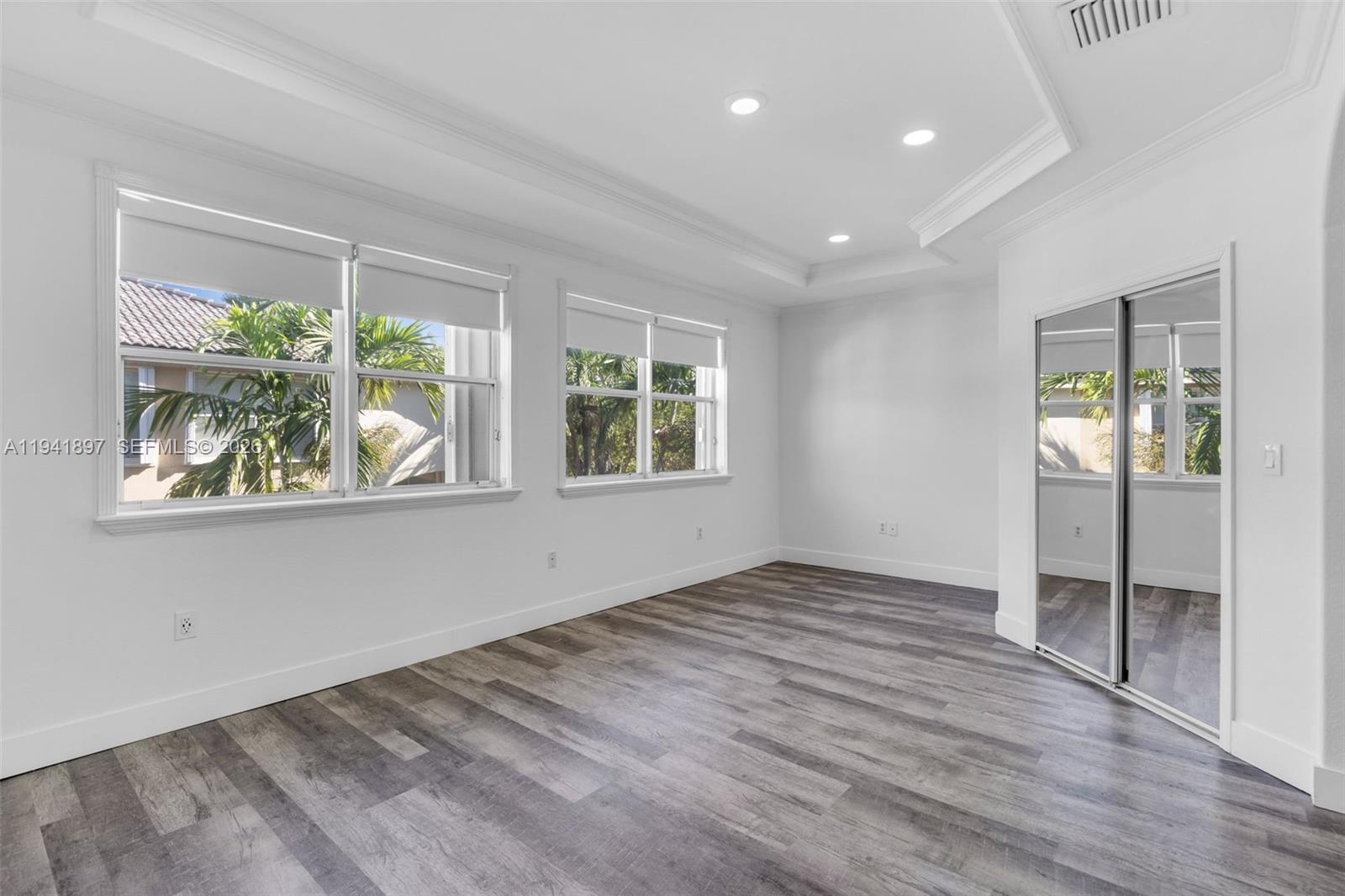 5505 Northwest 112th Path, Unit 5505 Doral, FL 33178 - Photo 28 of 44 wooden floor in an empty room with a window