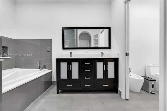 a bathroom with a toilet a sink and a bathtub