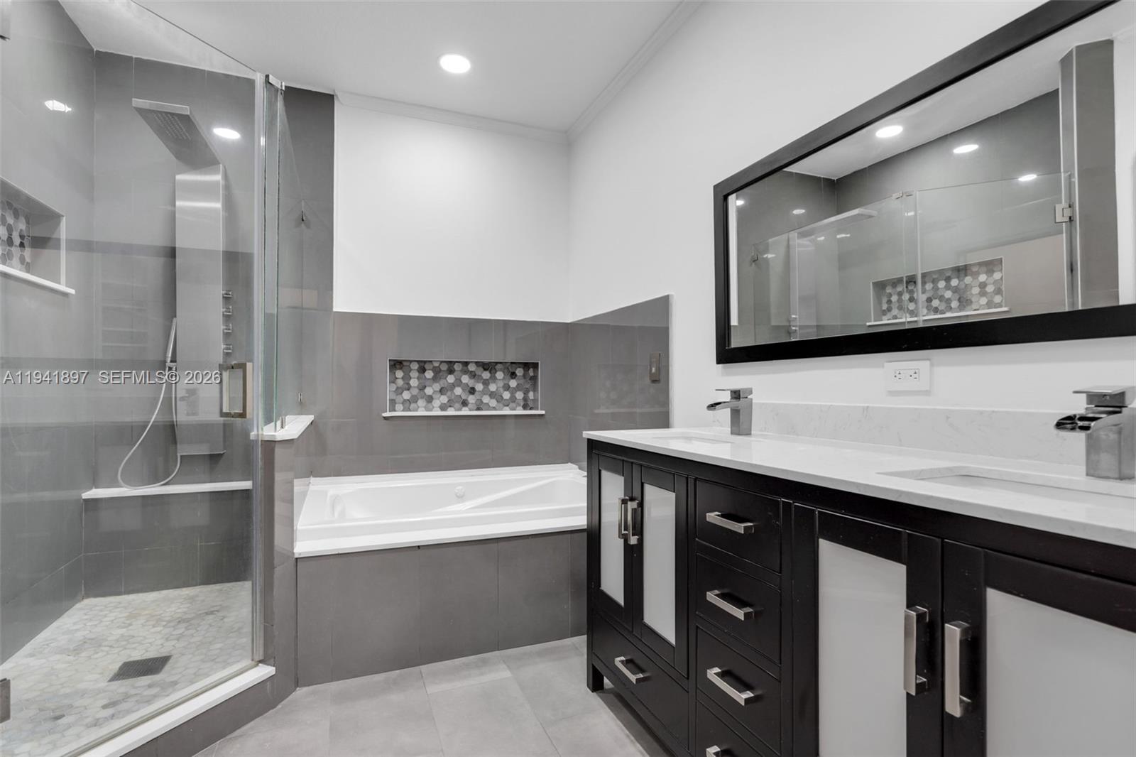 5505 Northwest 112th Path, Unit 5505 Doral, FL 33178 - Photo 31 of 44 a bathroom with a sink a mirror and a bathtub