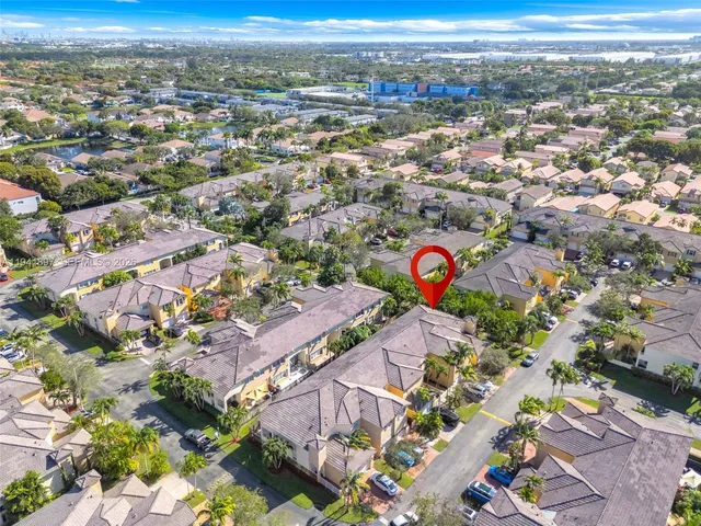 an aerial view of residential houses with outdoor space