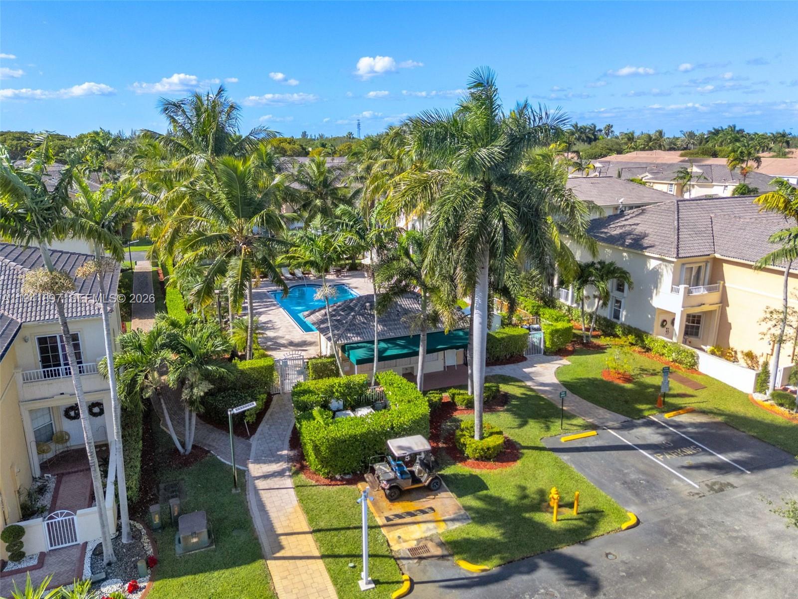 5505 Northwest 112th Path, Unit 5505 Doral, FL 33178 - Photo 43 of 44 a sign that is sitting in front of yellow house