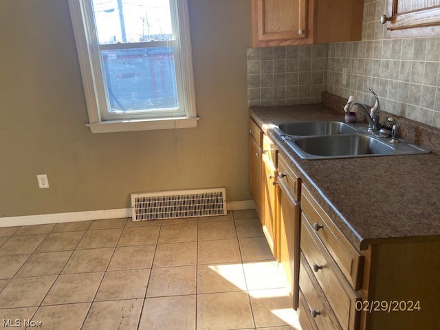 1650 Hillview Road Cleveland, OH 44112 - Photo 5 of 10 Kitchen with backsplash, light tile floors, and sink