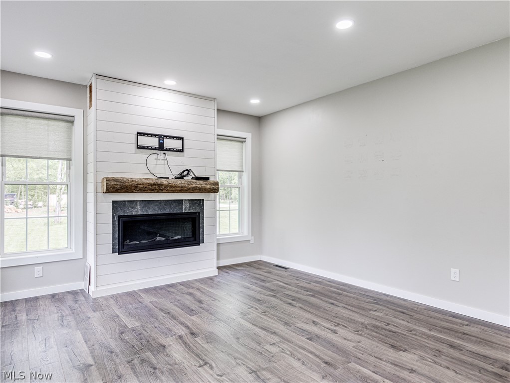 6573 Boneta Road Medina, OH 44256 - Photo 28 of 38 In law suite living room featuring a large fireplace and hardwood / wood-style floors