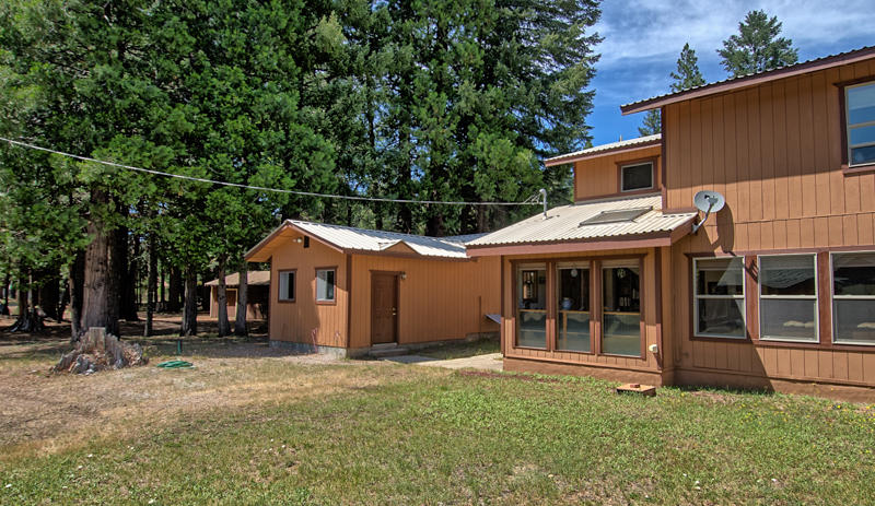 9375 Thatcher Mill Road Shingletown, CA 96088 - Photo 1 of 23 a house with trees in the background
