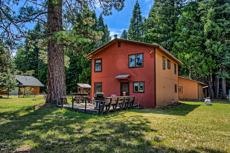 9375 Thatcher Mill Road Shingletown, CA 96088 - Photo 12 of 23 a backyard of a house with yard table and chairs
