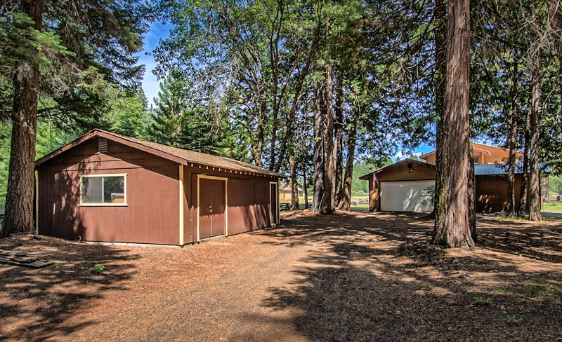 9375 Thatcher Mill Road Shingletown, CA 96088 - Photo 14 of 23 a front view of a house with a yard and garage