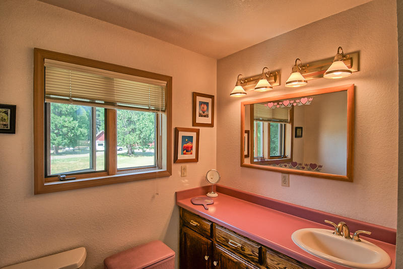 9375 Thatcher Mill Road Shingletown, CA 96088 - Photo 16 of 23 a bathroom with a toilet sink and mirror
