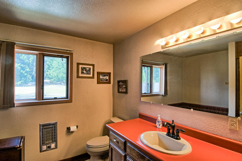 9375 Thatcher Mill Road Shingletown, CA 96088 - Photo 19 of 23 a bathroom with a sink a toilet and mirror