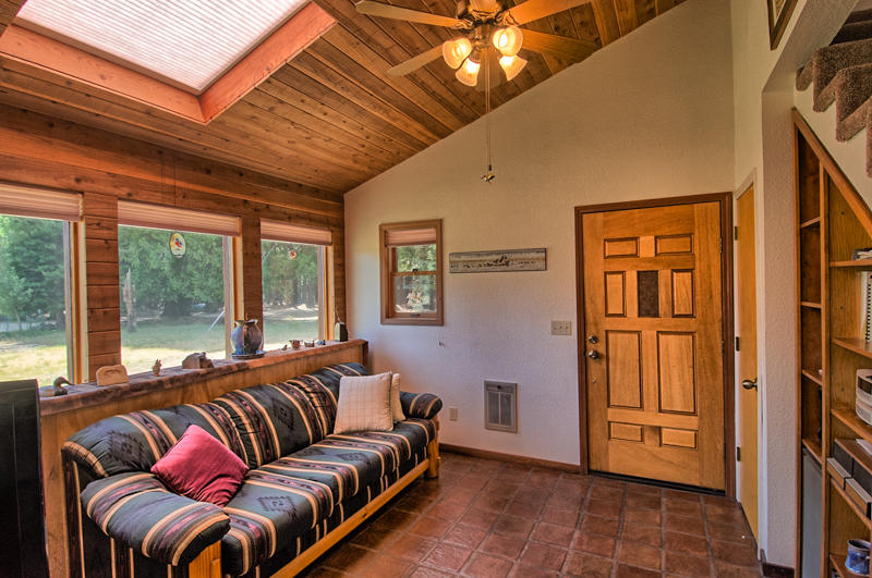 9375 Thatcher Mill Road Shingletown, CA 96088 - Photo 2 of 23 a living room with furniture a ceiling fan and a window