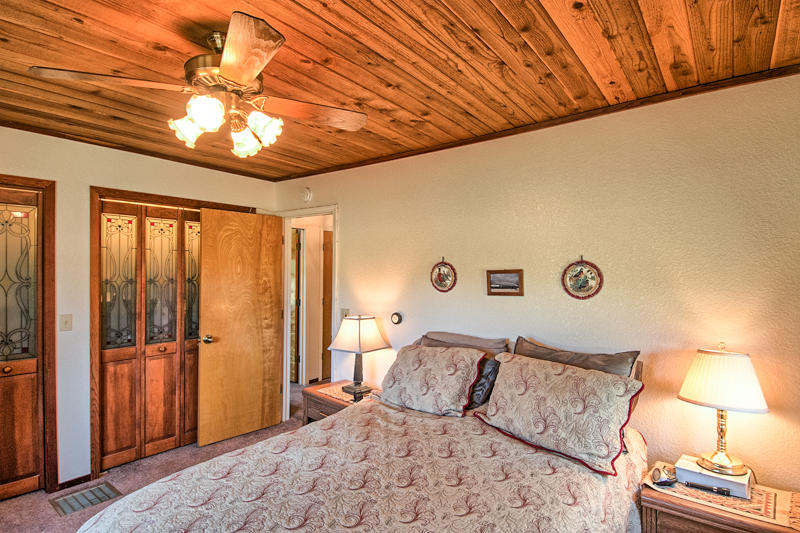 9375 Thatcher Mill Road Shingletown, CA 96088 - Photo 7 of 23 a bedroom with a bed and a lamp with the view of bathroom