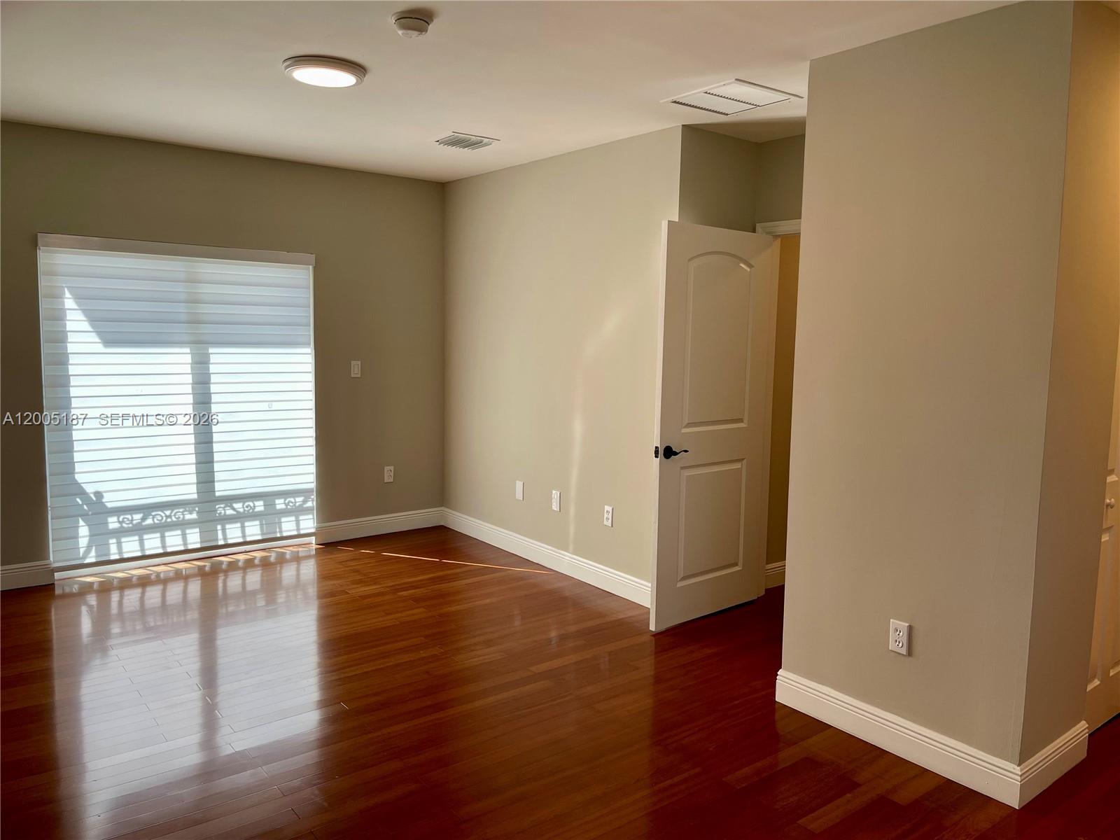 3191 Ohio Street Miami, FL 33133 - Photo 18 of 32 an empty room with wooden floor and windows