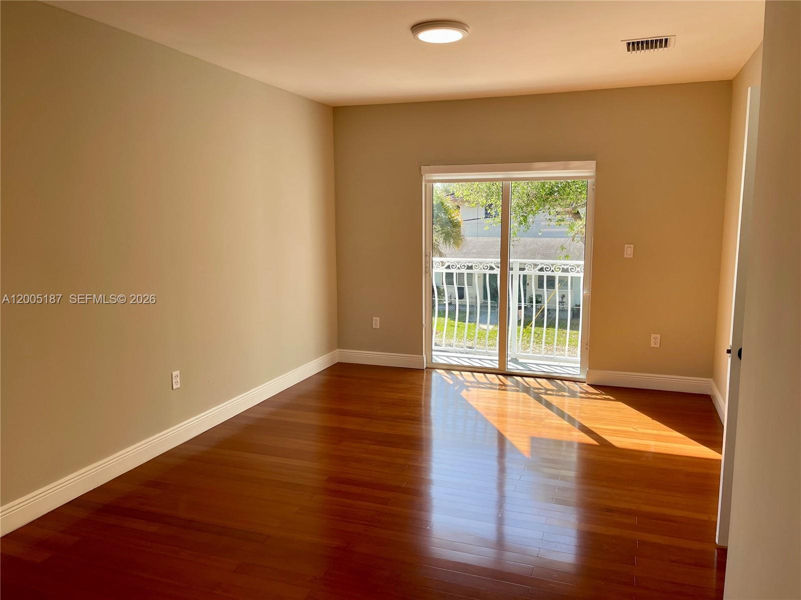 3191 Ohio Street Miami, FL 33133 - Photo 19 of 32 a view of an empty room with wooden floor and a window