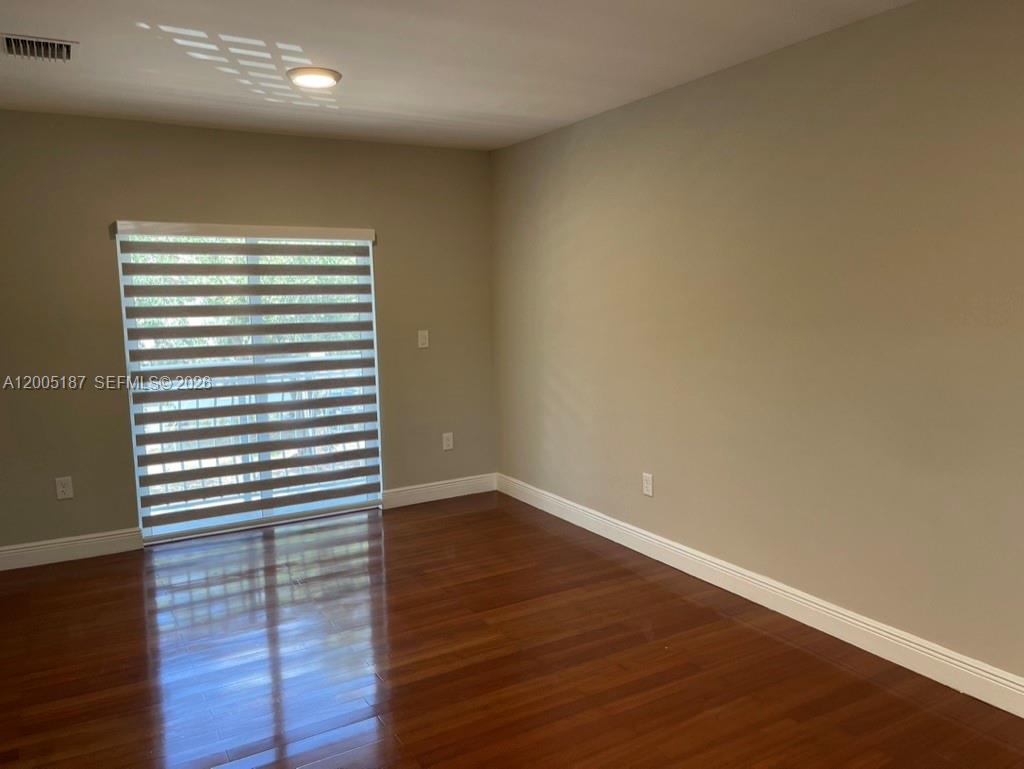 3191 Ohio Street Miami, FL 33133 - Photo 24 of 32 wooden floor in an empty room with a window