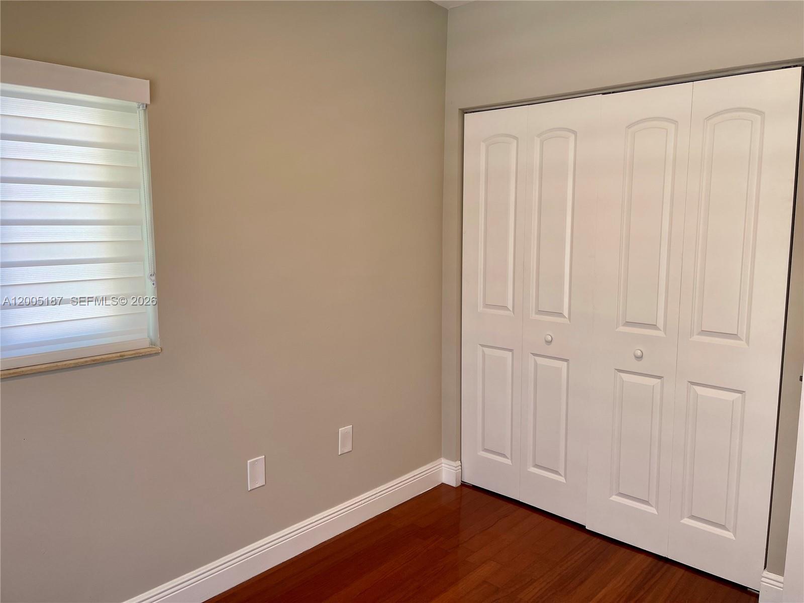 3191 Ohio Street Miami, FL 33133 - Photo 27 of 32 a view of an empty room with wooden floor and a window