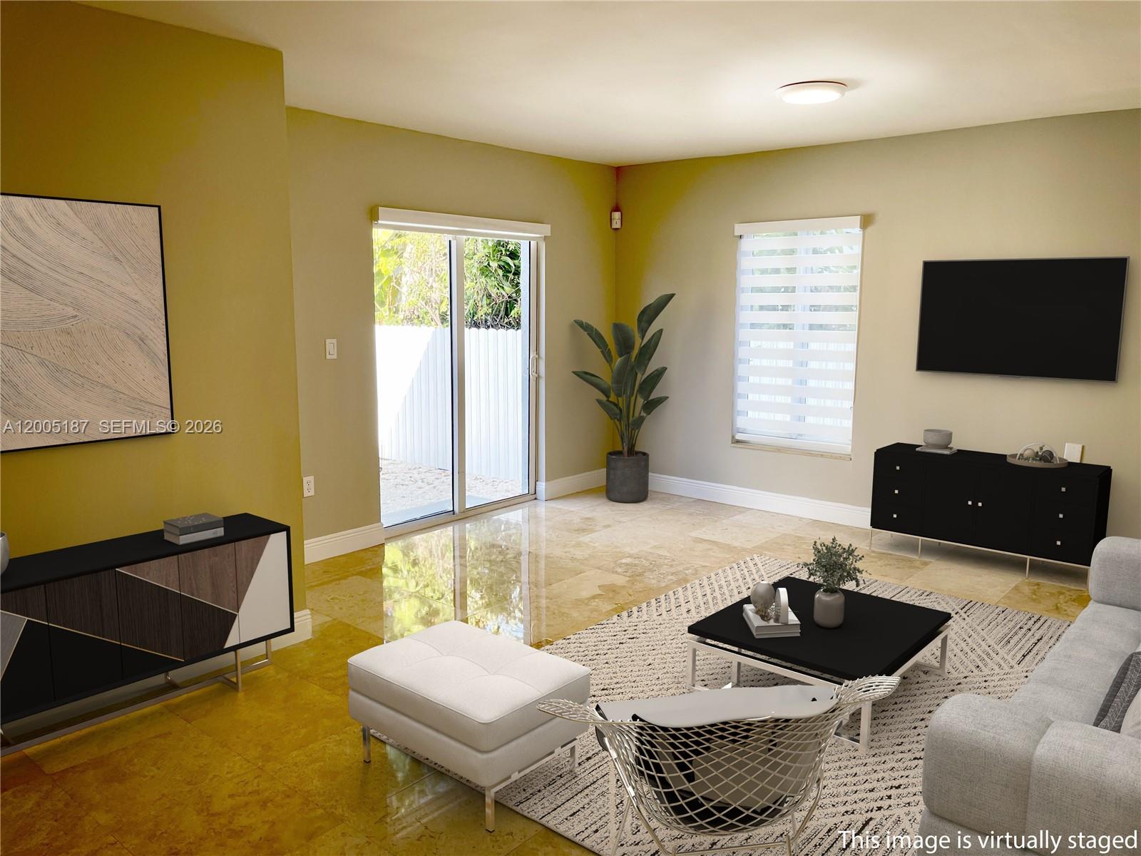 3191 Ohio Street Miami, FL 33133 - Photo 6 of 32 a living room with furniture and a flat screen tv