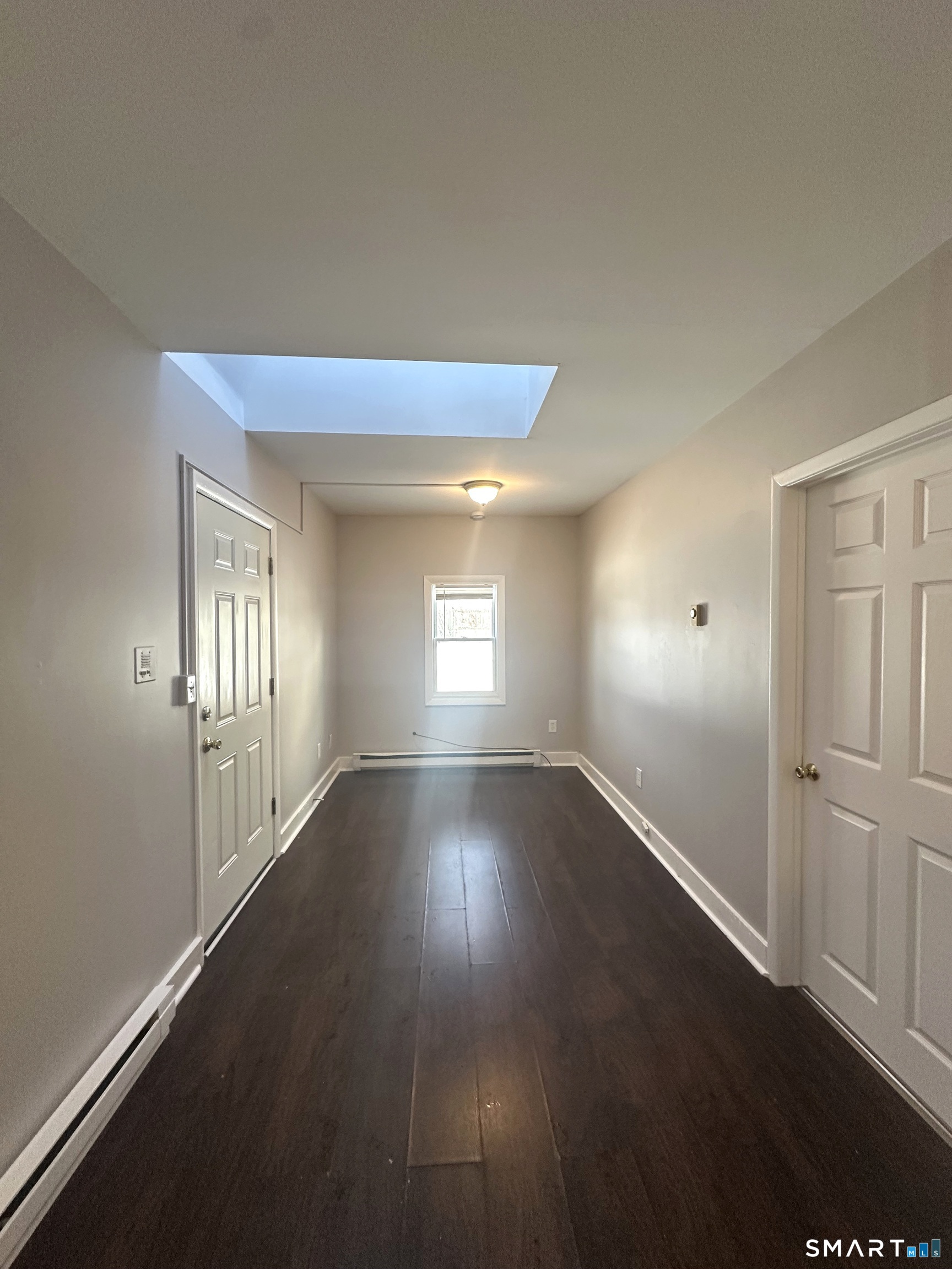 7 Prest Street, Unit 3 New London, CT 06320 - Photo 3 of 6 an empty room with wooden floor and windows