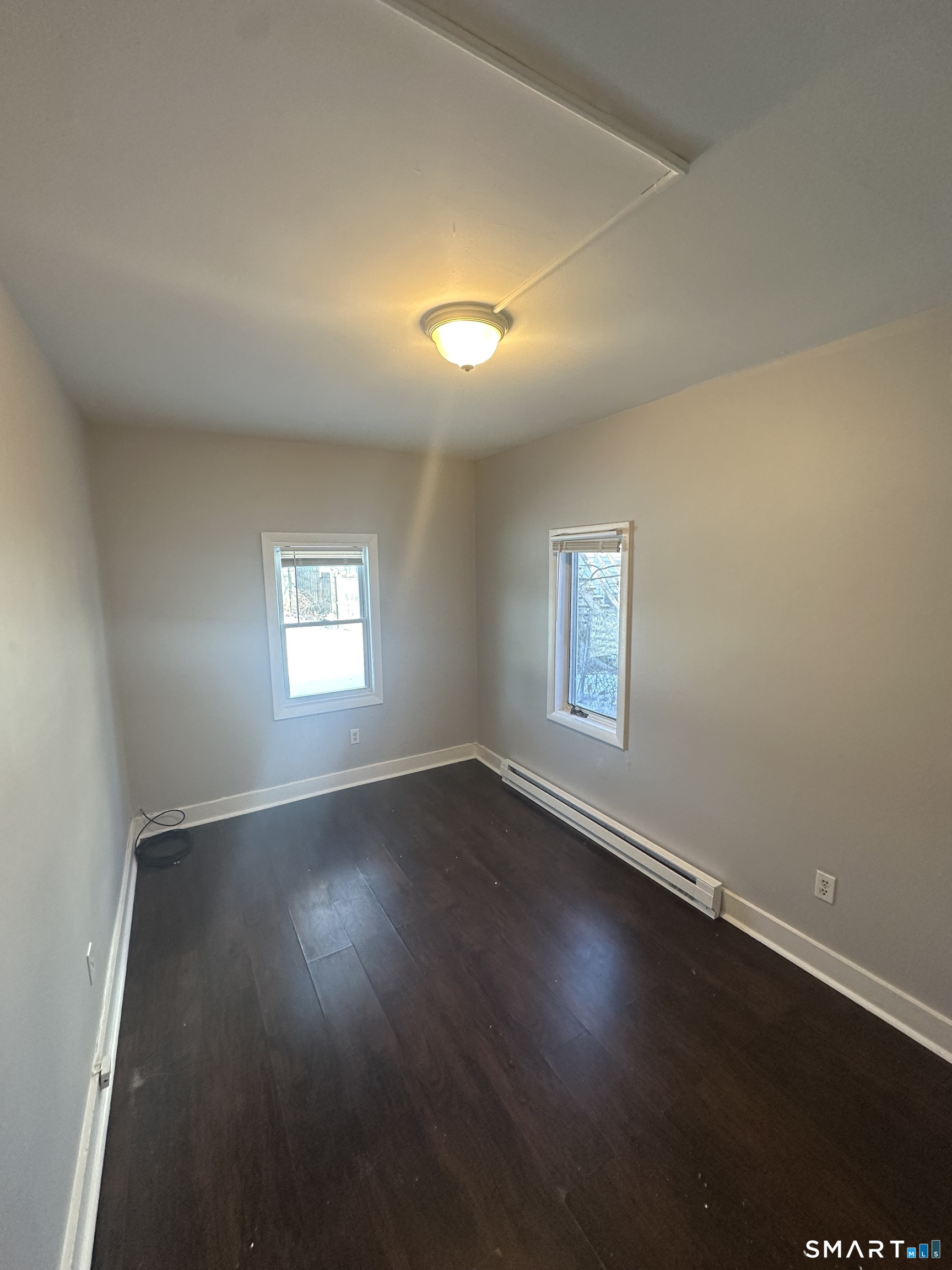 7 Prest Street, Unit 3 New London, CT 06320 - Photo 5 of 6 an empty room with wooden floor and windows