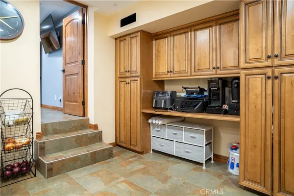 a kitchen with a refrigerator and cabinets