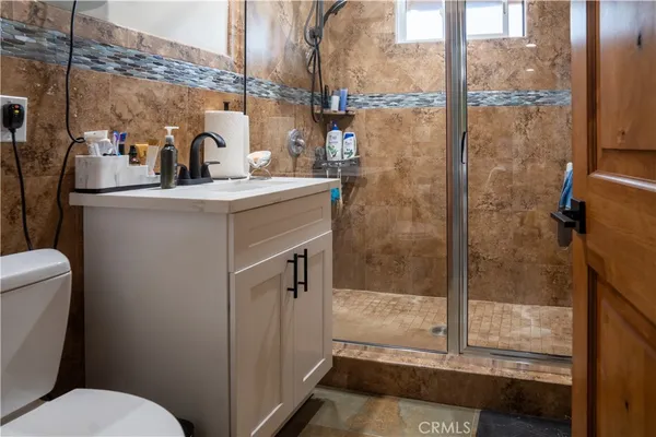 a bathroom with a sink toilet and shower