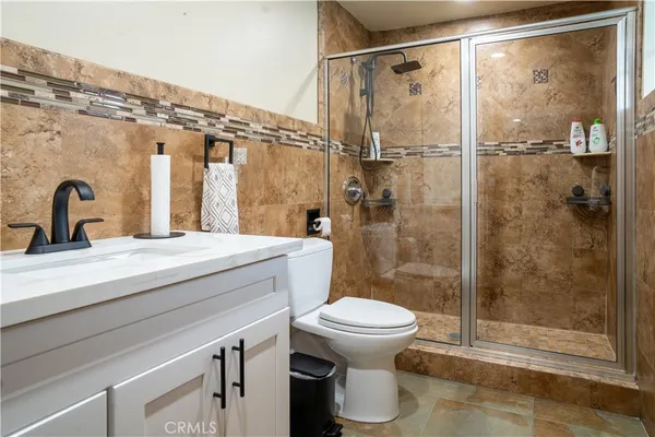 a bathroom with a shower a toilet and a sink