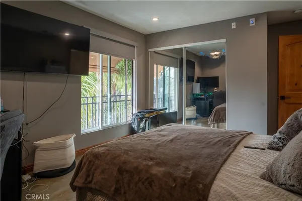 a bedroom with a large bed and a large window